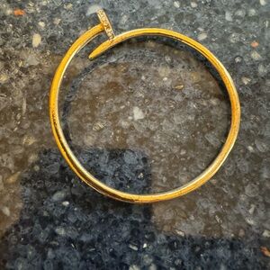 Bangle bracelet- goldtone nail design with rhinestone accent